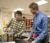 A male student teacher in the Professional Development School program works with a high school student in the classroom on a STEM project