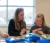 A female Dordt student works with a younger student at an elementary school