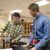 Professor and student discuss over students cardboard box project