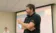 A professor roams around the room while teaching class