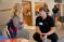 a male Dordt education student talks with a young student at an after school program