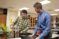 A male student teacher in the Professional Development School program works with a high school student in the classroom on a STEM project