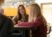 A student teacher works with a student in class