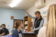 Faculty member points upward as she explains a concept at the front of a classroom
