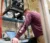 A student stands and is looking at a computer at an engineering lab station