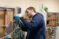 A student does wiring on equipment in the engineering technology lab