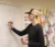 Male student works on math problem on the classroom white board