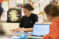 Female student works on mathematics project on desk