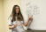 Female students points to a math problem on the classroom whiteboard
