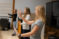Three female students practice arm positions in conducting class
