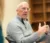 Dr. Christians gestures with his hands as he speaks to his psychology class