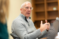 Dr. Christians gestures with his hands as he speaks to his psychology class
