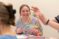 a female student smiles as a class plays the brain game