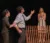 Three students perform on stage
