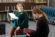 Two actresses run through lines in a class
