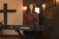 Female student sits at keyboard and sings in recording studio