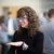 Young woman in glasses smiling and engaging in conversation
