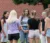 Group of young female adults stand in circle outside to pray