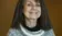 A picture of a woman in a sweater smiling