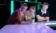 Three men lean on a counter