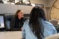 An MPA student talks with people in her office