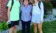 A grandmother stands with two grandchildren on the first day of class.
