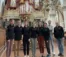 Students and faculty stand in front of famous organ