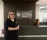 Director stands in front of Academic Enrichment Center front desk.
