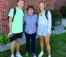 A grandmother stands with two grandchildren on the first day of class.