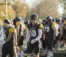 Football player walking next to the football field