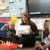 A Teacher sitting down with her students doing an activity