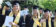 Dordt students in their cap and gown about smiling with their diplomas