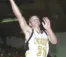 Old photo of young man playing basketball, going up for layup