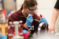 A Dordt student with safety glasses and gloves on looking into a test tube