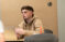 A Dordt student sitting at his desk looking at the front of the room with his laptop in front of him