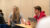 Two Dordt students sitting down looking at the front of the room smiling