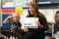 A masters in education student reads a picture book to children