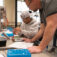 A Dordt Engineering Professor watching over a student doing an in-class activity