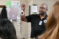 A Police Administration worker holding up a pair of handcuffs