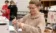 A nursing student prepares an IV bag in a nursing class