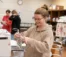 A nursing student prepares an IV bag in a nursing class