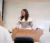 A Dordt Social Work Professor standing up in front of the class smiling