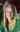 A picture of a women with blond hair wearing a green shirt