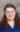 A picture of a women with brown hair wearing a blue shirt