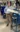 A picture of a man in a light blue shirt standing next to machinery