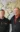 Two people in black jackets in front of a sketching of the world