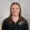 Photo of smiling young lady with straight hair wearing black quarter-zip