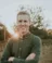 A picture of a man with a green shirt standing in Dordt's prairie