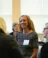 A smiling women talks to the people around her