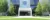 White building with black glass sections rises over landscape